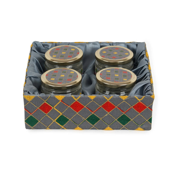 4 glass jars arranged on grey wooden tray